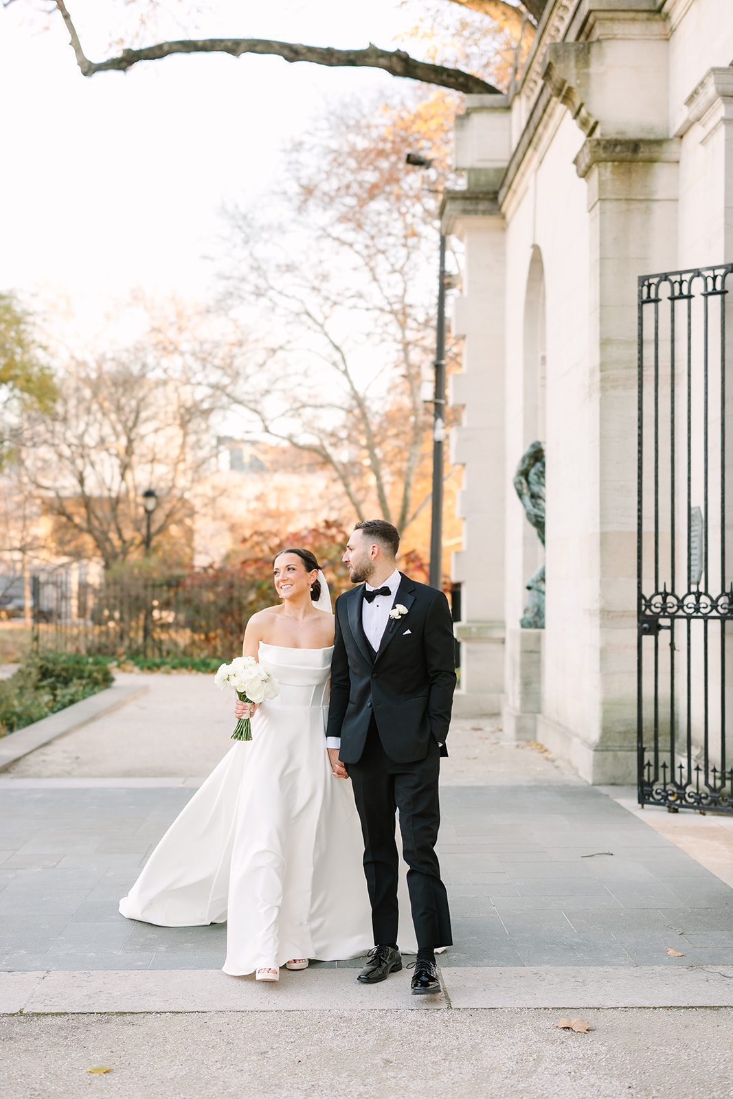 lexis and Chris posing at Rodin Museum on their wedding day